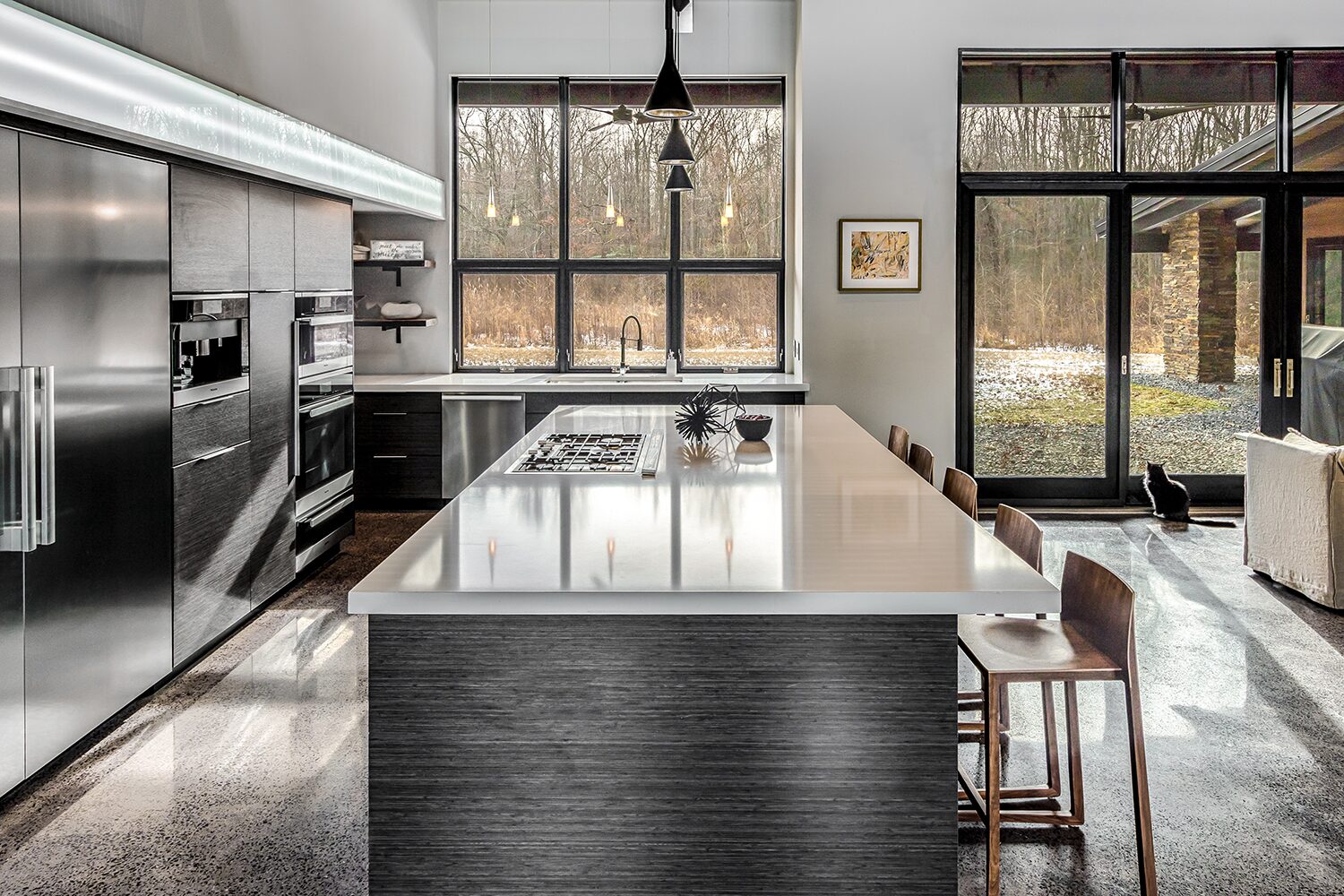 Custom modern kitchen with a waterfall island built by Taylor Made Custom Cabinetry